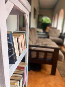 a book shelf filled with books in a living room at Paradise Inn Beach Resort in Varkala