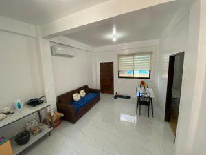 a living room with a couch and a table at Concetta Tourist Inn Apartelle with Pool in Manolo Fortich