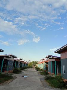 a row of colorful houses on a street at ต.รัตน รีสอร์ท in Ban Don Klang +11 photos