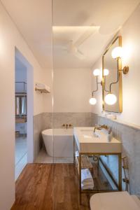 a bathroom with a sink and a bath tub at The Charleston in Galle