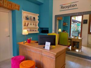 a reception desk in a store with a computer and chairs at Corte del Fuin - Dreaming Italy Travel in Seregno