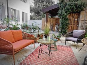 a patio with a couch and a table and chairs at Corte del Fuin - Dreaming Italy Travel in Seregno