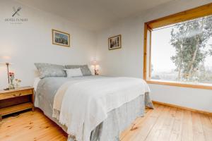 A bed or beds in a room at Hotel Fundo Las Tortolas