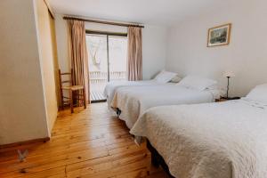 A bed or beds in a room at Hotel Fundo Las Tortolas