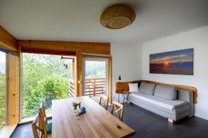 a living room with a wooden table and a couch at Panorama Apartment Bauernhof Mandl in Murau