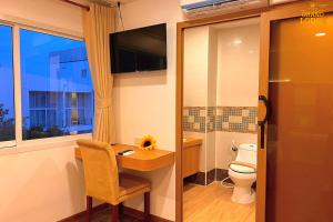 a bathroom with a desk and a toilet and a television at The Grand Lodge Pattaya in Pattaya +87 photos