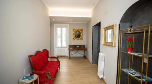 a living room with a red couch and a table at Palazzo Brienza in Potenza