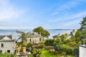 an aerial view of a house with the ocean in the background at Seaside Luxury Escape in Aberdour