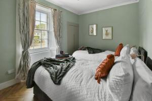 a bedroom with two beds and a window at Seaside Luxury Escape in Aberdour