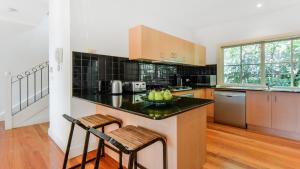 a kitchen with a bowl of apples on a counter at Boutique Stays - Brighton Abode in Melbourne