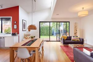 a kitchen and living room with a table and chairs at Boutique Stays - Mordi Beach House in Mordialloc