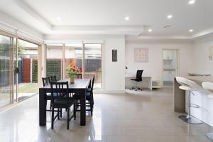 a kitchen and dining room with a table and chairs at Boutique Stays - Mentone Abode in Mentone