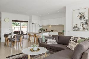 a living room and kitchen with a couch and a table at Boutique Stays - The Richardson in Mentone