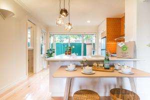 a kitchen with a table with two chairs and a sink at Boutique Stays - Buckingham in Melbourne