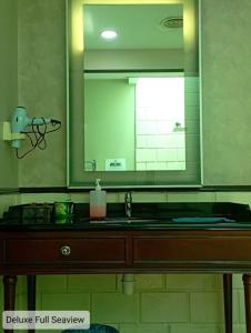 a bathroom with a sink and a large mirror at Alpine LXPD Full Seaview Water Chalet in Port Dickson