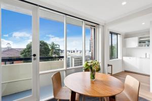 a dining room with a table and a large window at Boutique Stays - Ace's Place in Melbourne