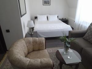 a living room with a bed and a couch at Hotel KREZ in Qyzylorda