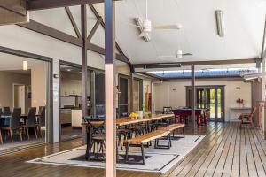 a dining room with tables and chairs in a building at A Perfect Stay - Lennox Coastal Retreat in Lennox Head