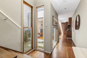 a hallway with sliding glass doors in a house at Boutique Stays - Curran Terrace in Melbourne