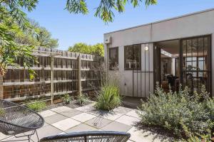 a house with a fence and a patio at Boutique Stays - Curran Terrace in Melbourne