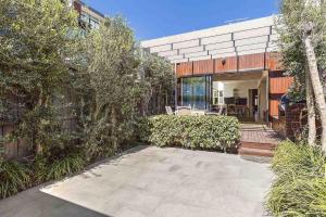 a house with a patio in front of a building at Boutique Stays - Victorian Vogue in Melbourne