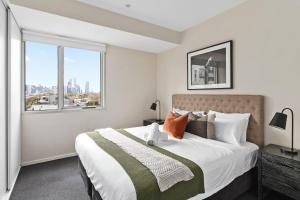 メルボルンにあるBoutique Stays - Zinc Views 501のベッドルーム1室(大きなベッド1台、大きな窓付)