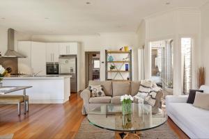 a living room with a couch and a table at Boutique Stays - Mordi Sands in Mordialloc
