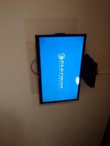a flat screen tv hanging on a wall at Sunrise Center Ngousso Yaounde in Yaoundé