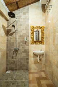 a bathroom with a sink and a mirror on the wall at Nirmala Guest House Surf Keramas in Keramas