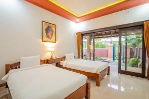 Nirmala Guest House Surf Keramas客房内的一张或多张床位