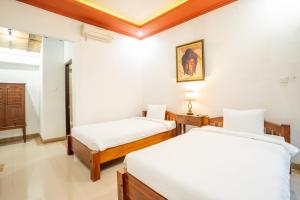 Nirmala Guest House Surf Keramas客房内的一张或多张床位