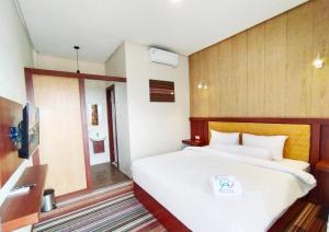 Postel nebo postele na pokoji v ubytování Hotel Syariah GS Lampung Culture, Bandar Lampung