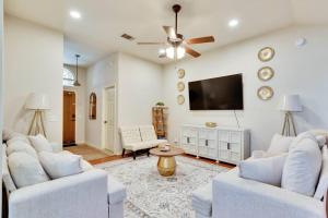 a living room with white furniture and a flat screen tv at Charming and Comfort 3BR/2BA Retreat in Kyle in Kyle