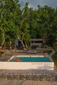 a swimming pool with a sign that reads south cyprusyards at South Pacific Memories in Port Vila