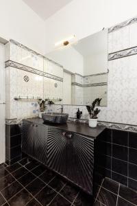 een badkamer met een wastafel en een grote spiegel bij Cozy 4BHK Villa in Bangalore