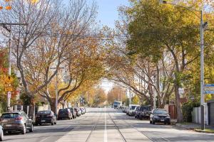 a tree lined street with cars parked on the street at Boutique Stays - Cherrybombe in Melbourne +9 photos