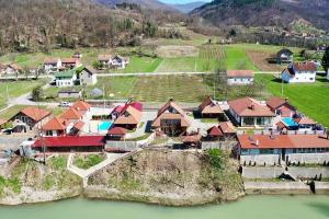 an aerial view of a village with houses and a river at Mini Deluxe Apartman Nature Connection Drina in Bajina Bašta
