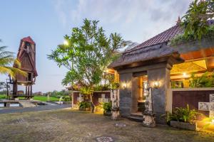 a house in the middle of a street at Nirmala Guest House Surf Keramas in Keramas