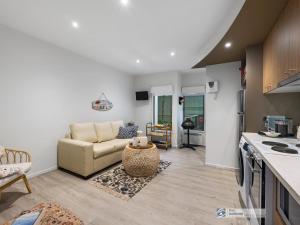 a living room with a couch and a kitchen at 341 The Waves, Cowes in Cowes +5 photos