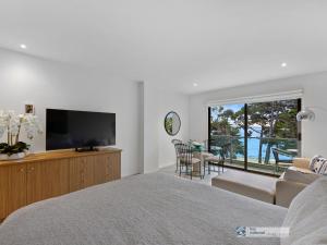 a bedroom with a television and a living room at 341 The Waves, Cowes in Cowes