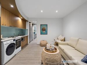 a living room with a couch and a table at 341 The Waves, Cowes in Cowes