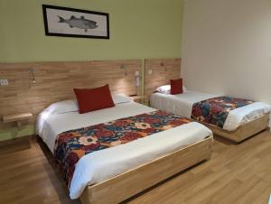 a hotel room with two beds in a room at Le Libenter in Landéda +8 photos