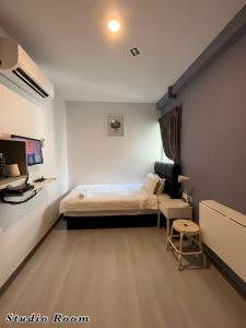 a bedroom with a bed and a tv in it at Havona Hotel - Kulai in Kulai