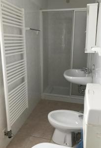 y baño con aseo, lavabo y ducha. en La Pineta - Appartamenti In Villetta, en Pinzolo
