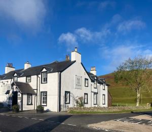 a large white house on the side of a street at The Gordon Arms Restaurant with Rooms in Yarrow