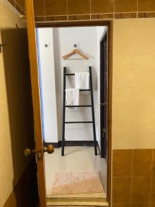 a bathroom with a towel rack and a ladder in a mirror at กัญญ่า เพลส KANYA in Maha Sarakham +47 photos