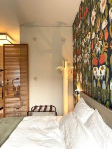 ein Schlafzimmer mit einem Bett und einem Gemälde an der Wand in der Unterkunft Industriële WOW! Private studio 35m2 in Amsterdam