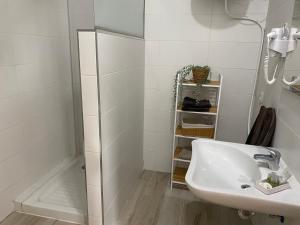 a white bathroom with a sink and a shower at SUNNY DAY DELUXE 1 B in Arguineguín