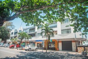 a building on a street with a car parked in front at Gorgeous KEJ in Pereybere 2 Bed Apartment in Pereybere