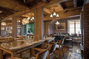 a restaurant with wooden walls and tables and chairs at Sundvolden Hotel in Sundvollen